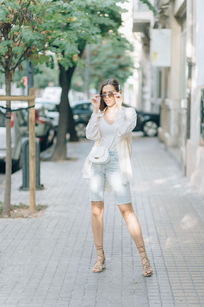 Woman in white street style on a city sidewalk
