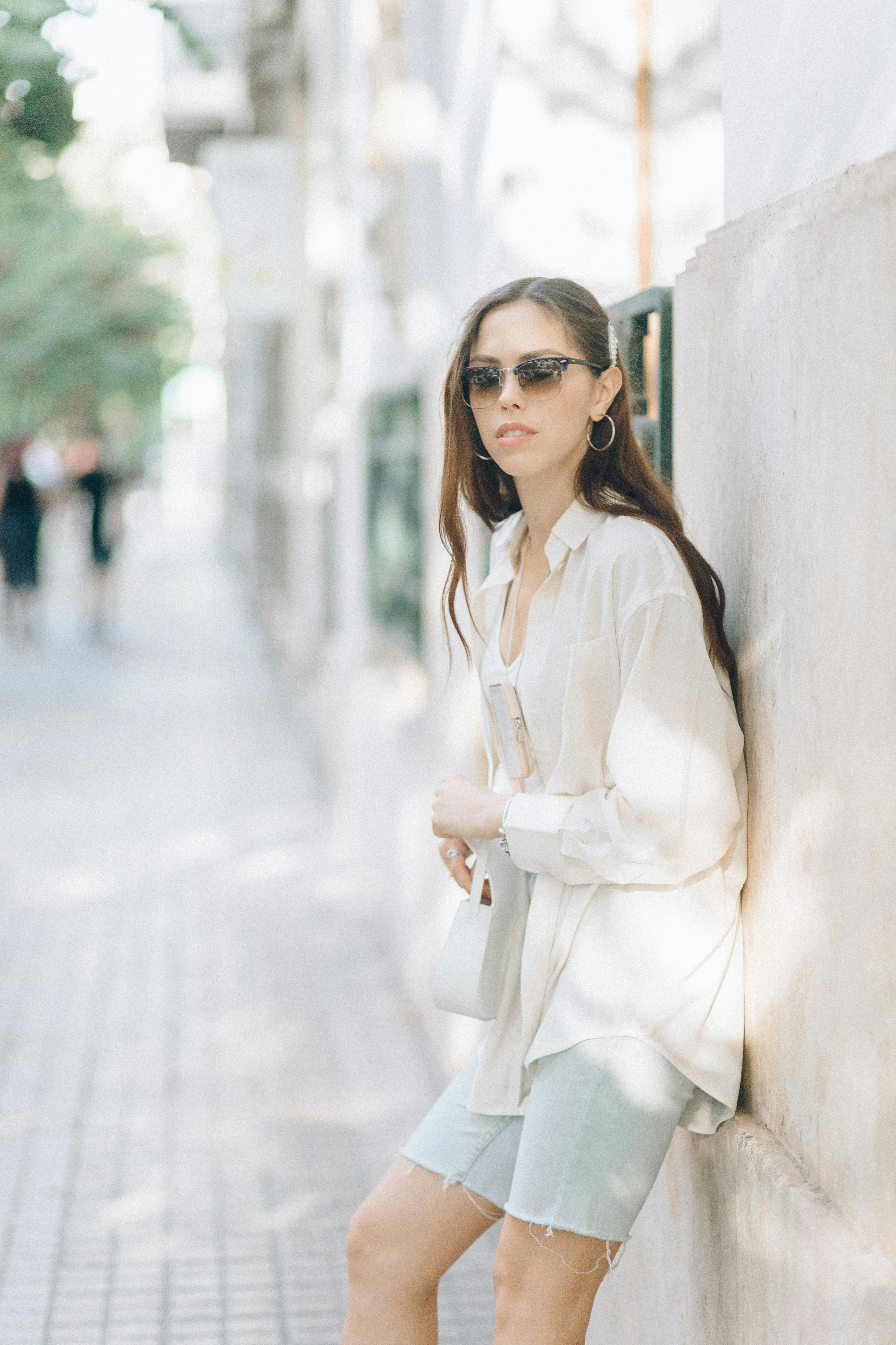 woman in white long sleeve dress wearing black sunglasses