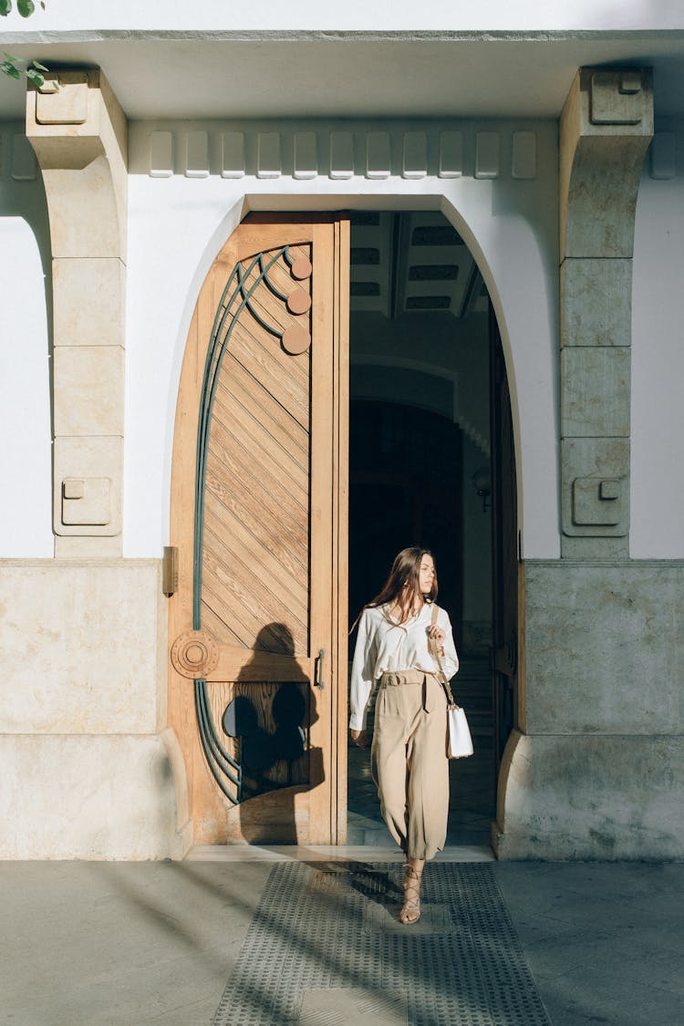 Woman Walking Out Of A Building