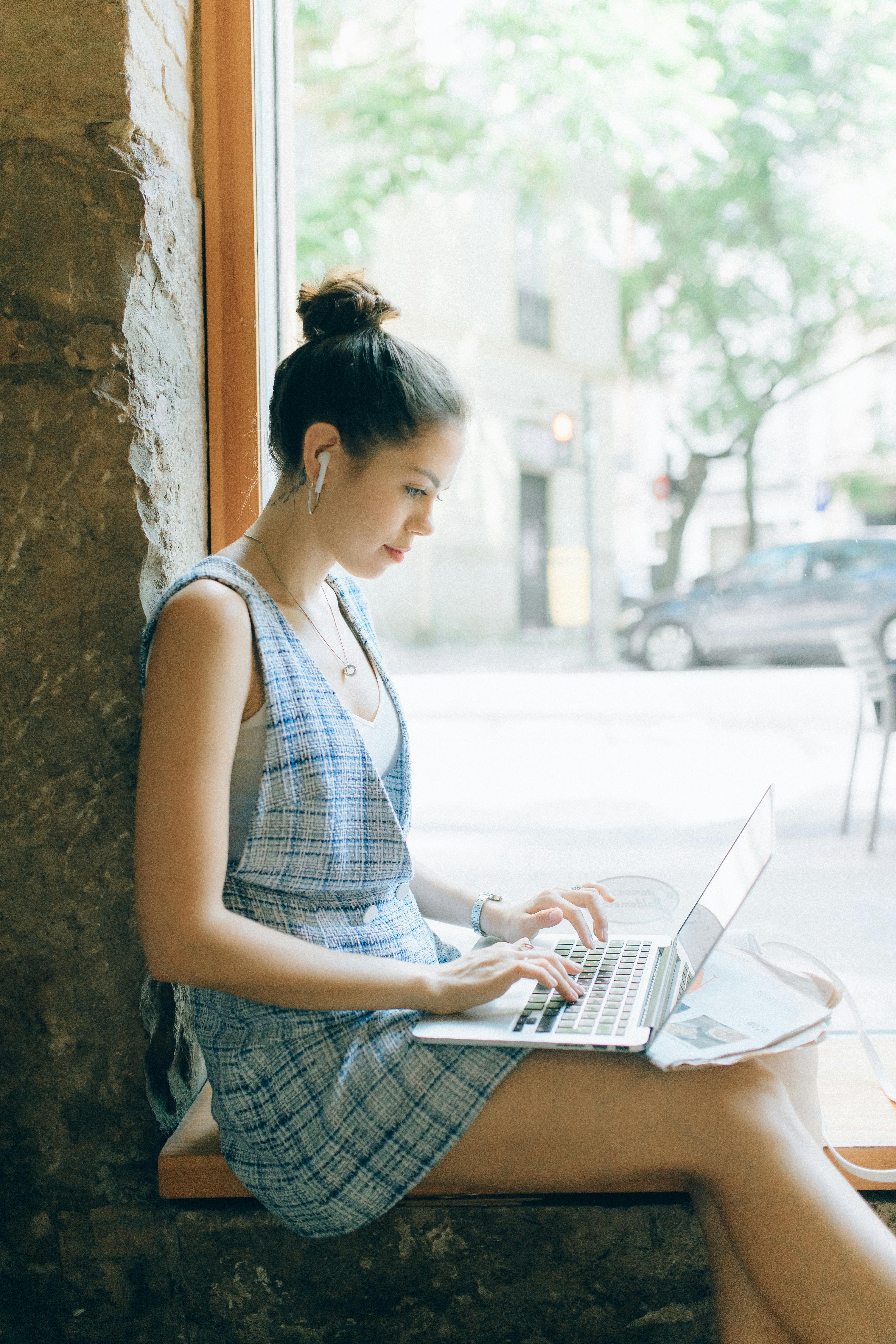 woman in short dress using laptop computer