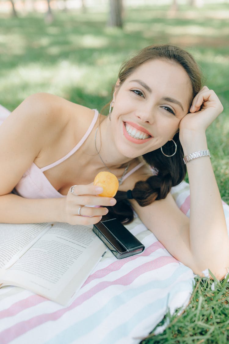 Smiling Woman Holding A Plum Fruit