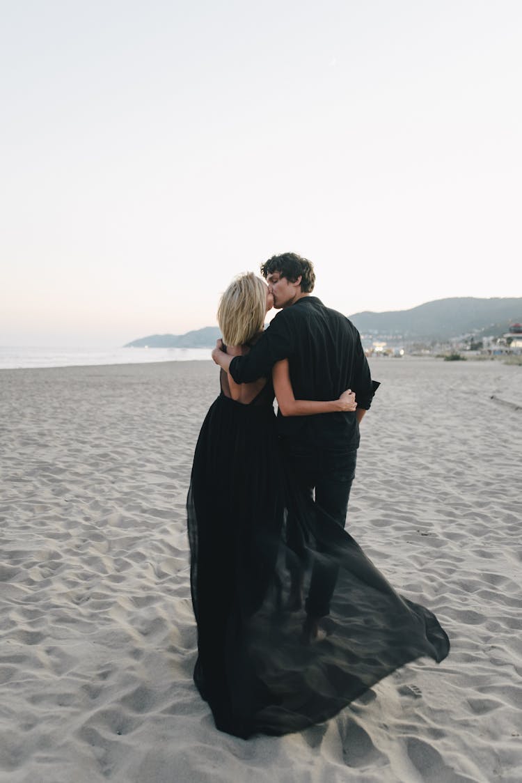 Man And Woman Kissing On Beach