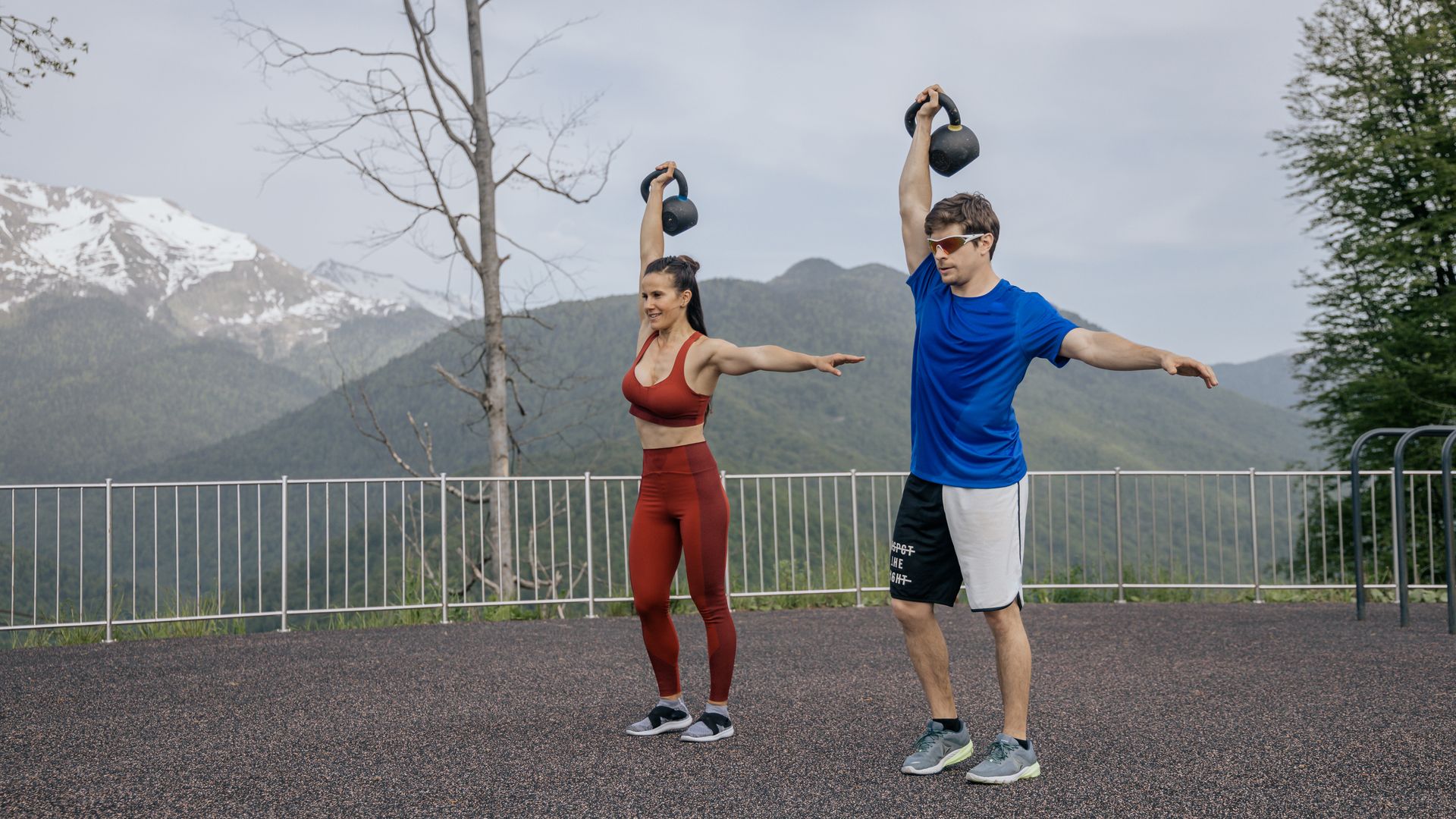 Exercise Unlocking for Beginners: Your Comprehensive Guide A fit couple exercises outdoors with kettlebells against a scenic mountain backdrop, showcasing a healthy lifestyle — exercise unlocking for beginners
