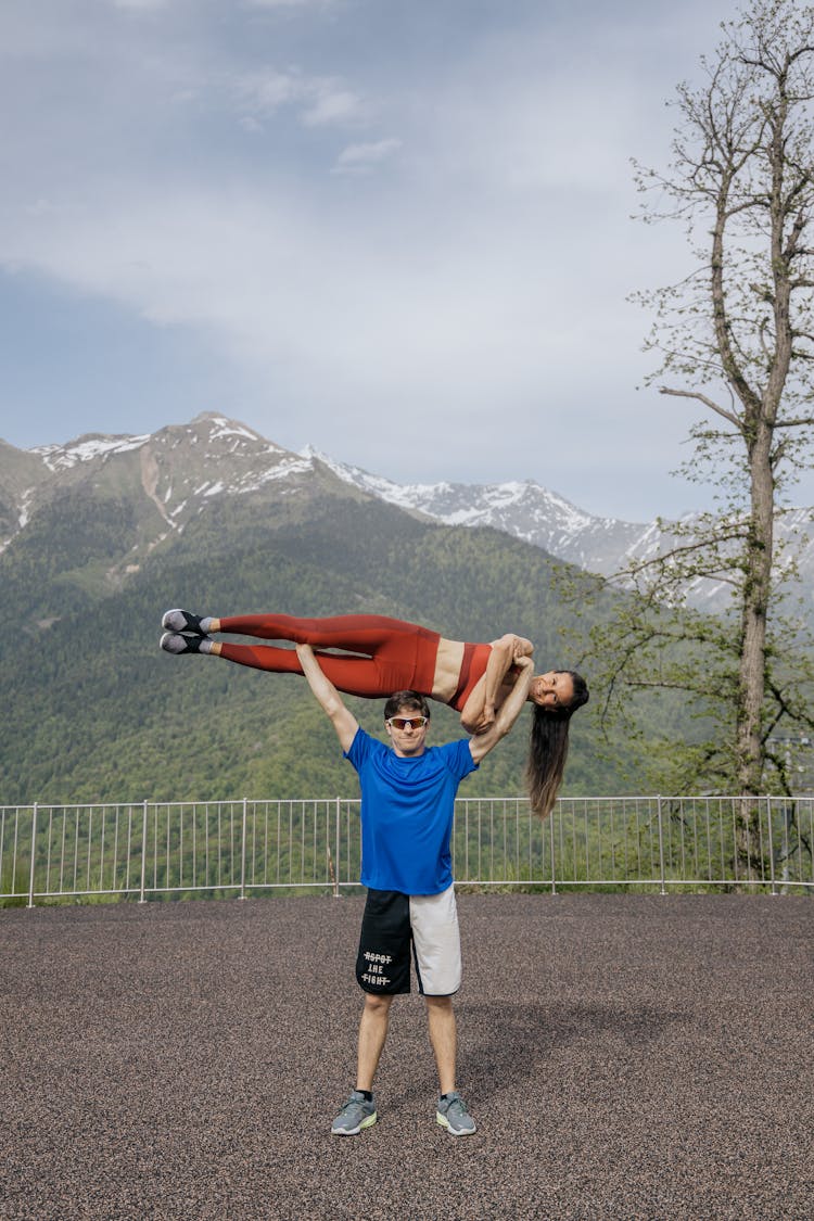 A Man Lifting A Woman