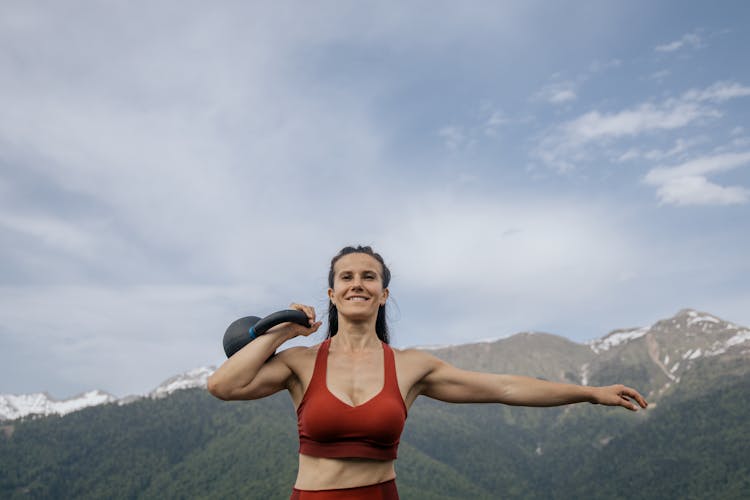 A Woman Lifting A Kettlebell