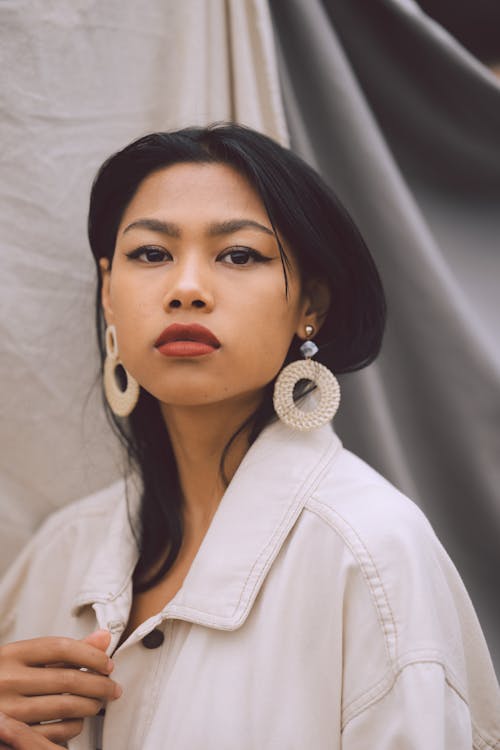 Stylish Asian woman in light room