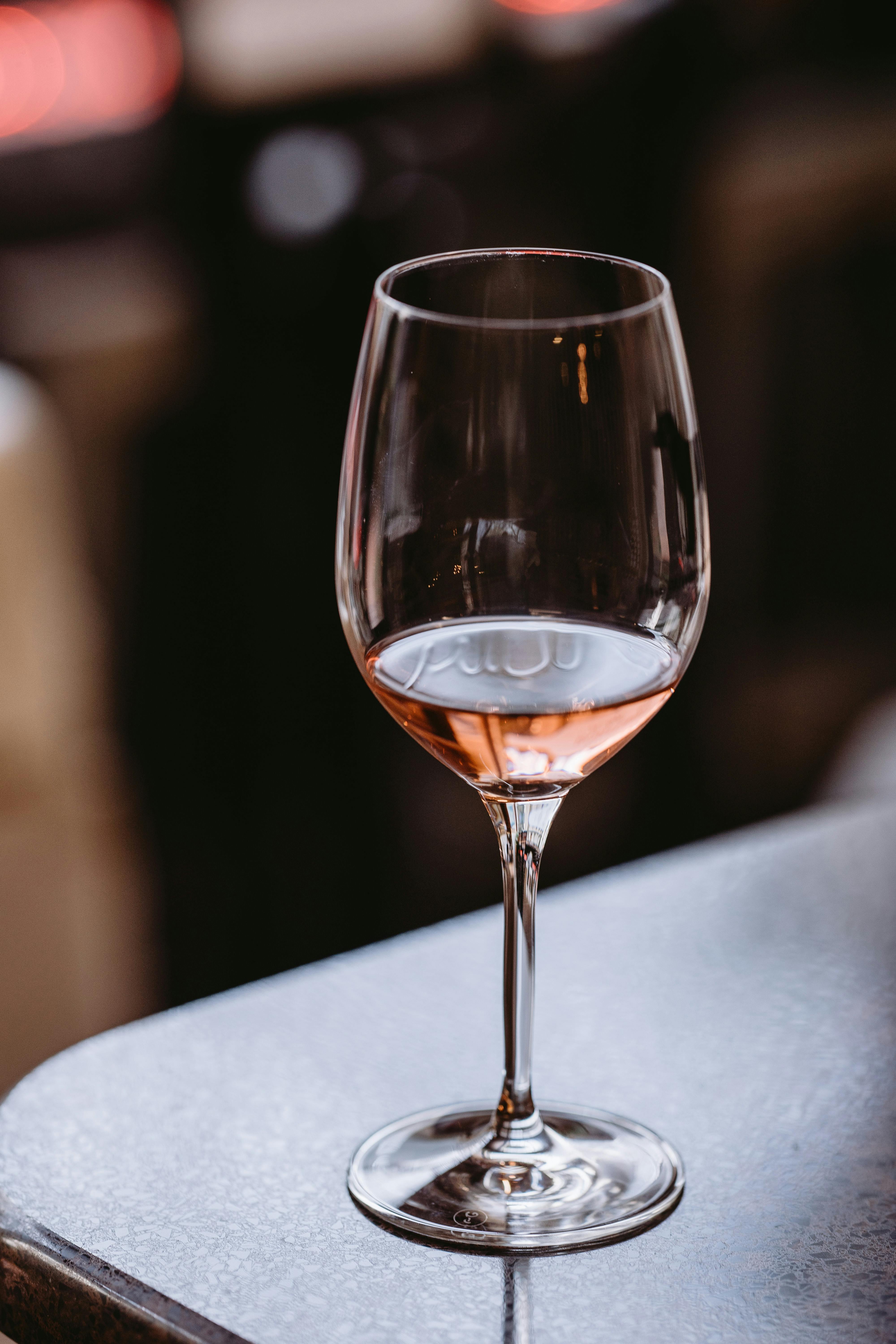 glass of fine rose wine on table