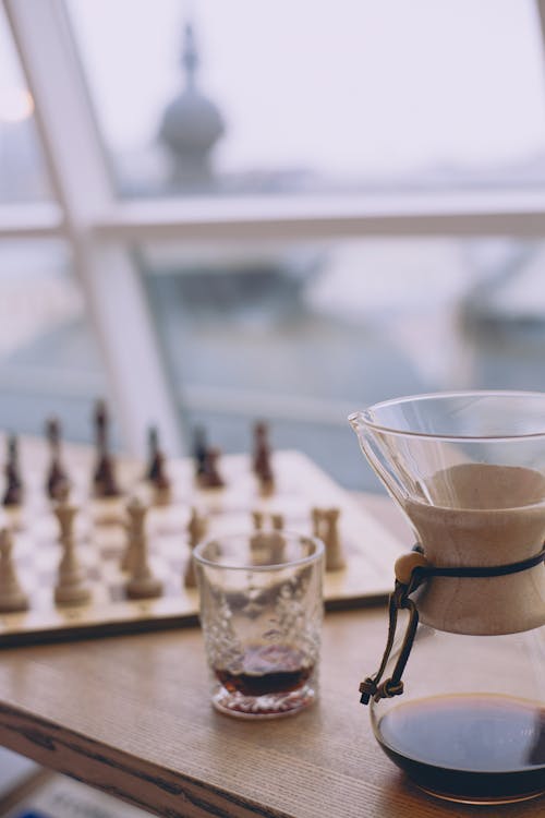 Free Table with coffee and glass against window Stock Photo