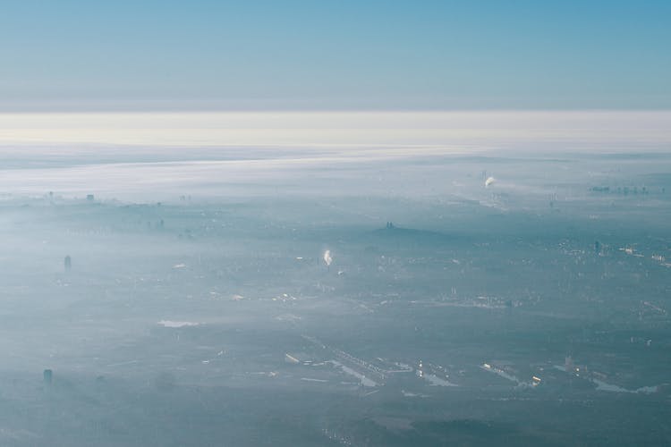 City In Thick Fog And Clouds