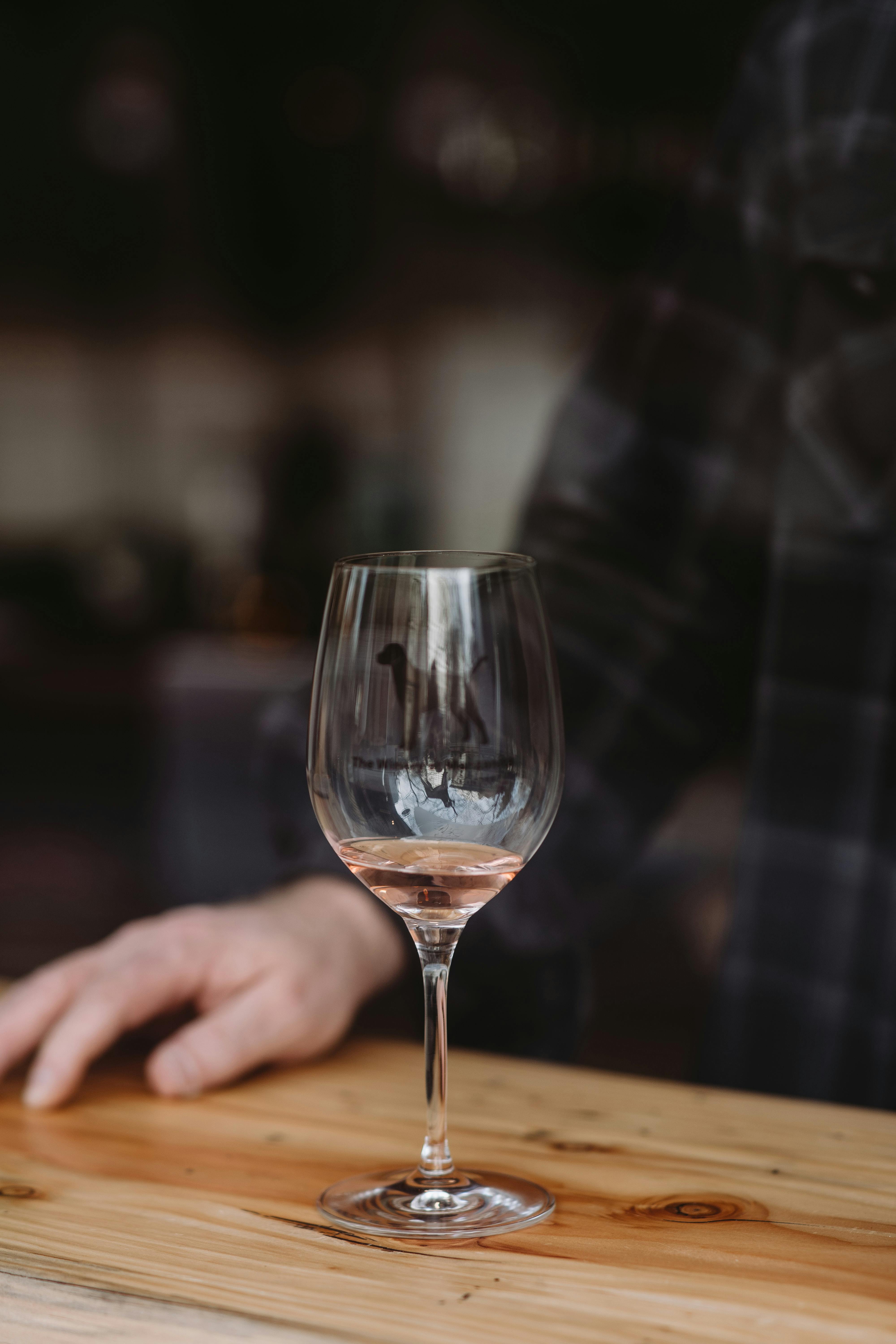 Man resting at table with glass of wine