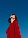 Stylish Asian woman with bright red lips enjoying sunny weather