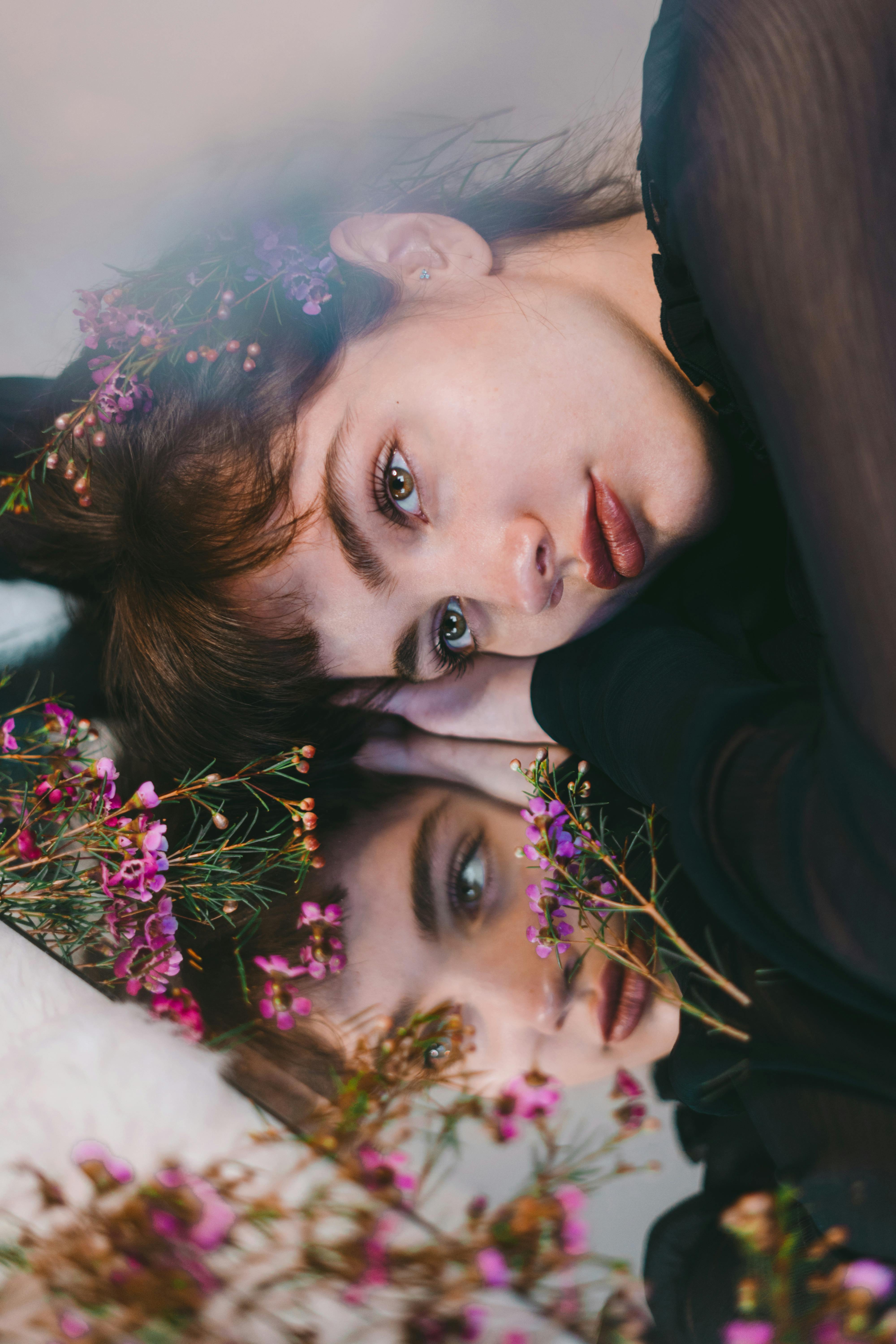 young content woman among gentle purple flowers