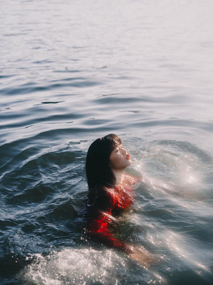 Woman Swimming In A River