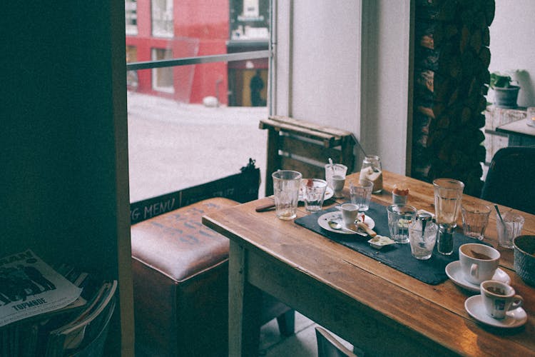 Table With Empty Dishware In Cafe