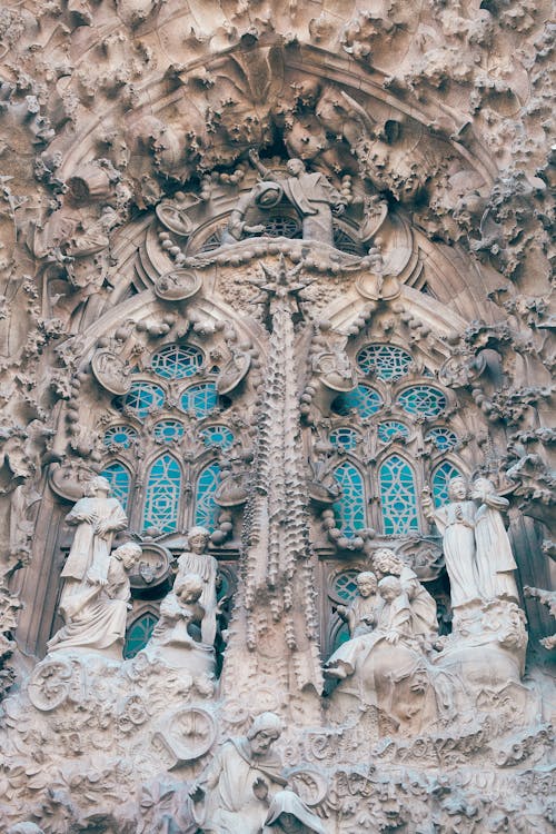 Free From below of aged stone Sagrada Familia church with carved elements and sculptures in Gothic style in Barcelona Stock Photo