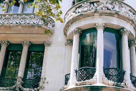 From below of aged ornamental apartment building decorated with carved elements on balconies