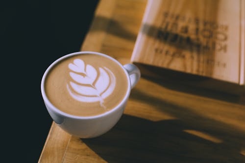 Cup of coffee with art on milky foam