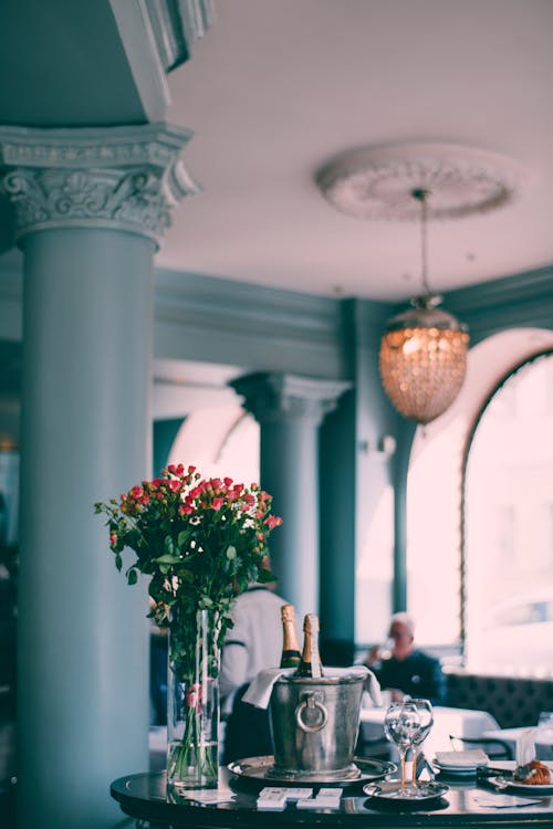 Table served with flowers and bucket with champagne in restaurant