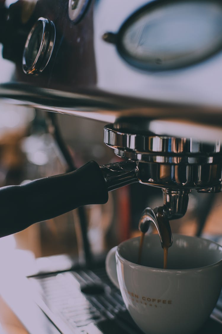 Cup Placed Under Coffee Machine In Cafe