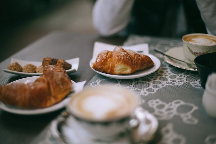 Crop Person With Coffee And Croissant