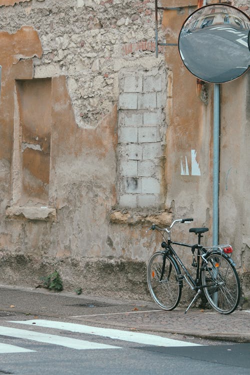 Bicycle on pavement near wall