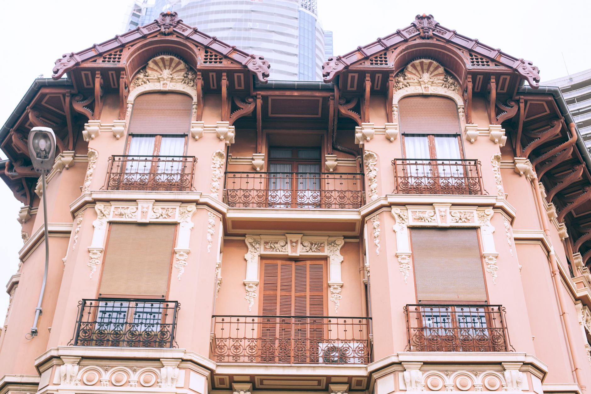 From below exterior of modern residential building with balconies decorated with carved and ornamental elements