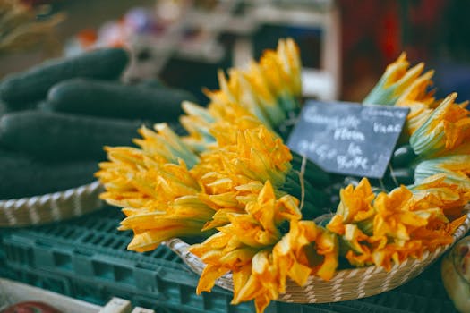 Vibrant zucchini flowers displayed at a market for sale. Ideal for recipes and nutrition.