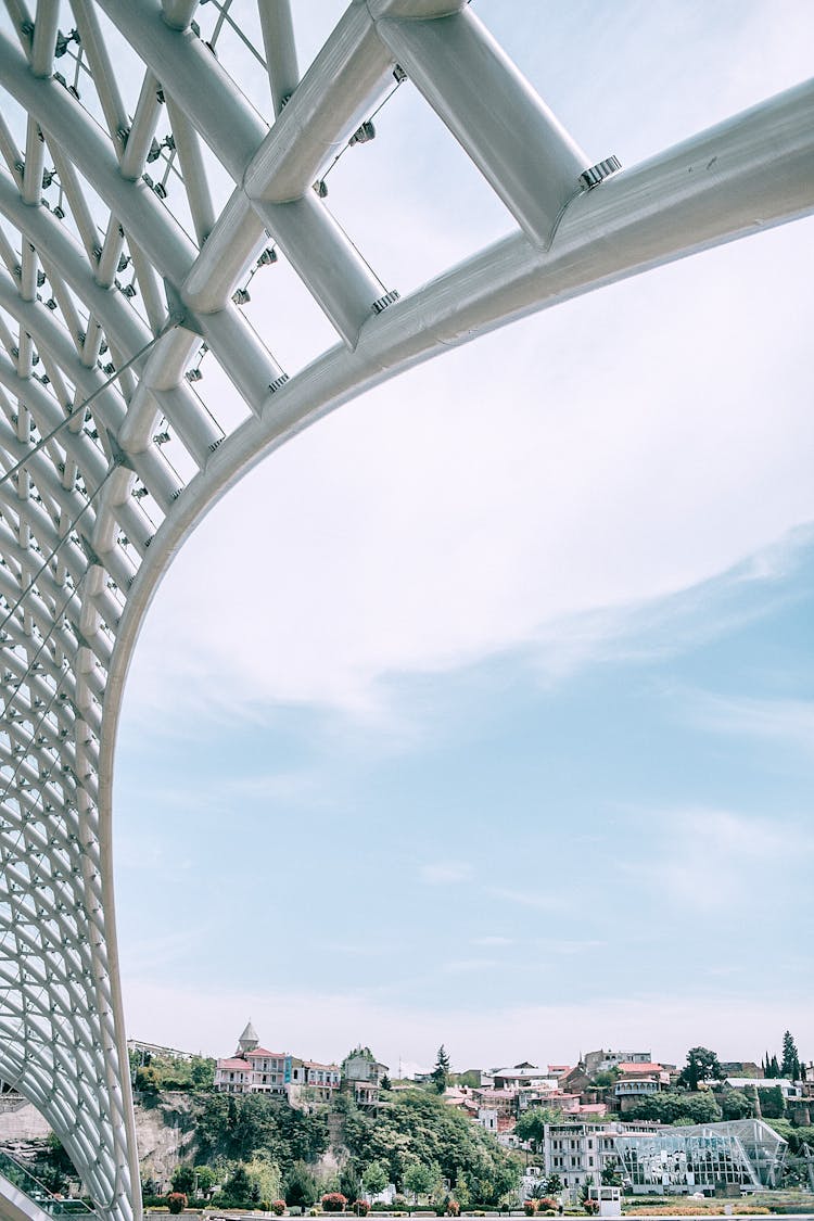 Stainless Steel Framework Of Modern Bridge In City On Partly Cloudy Day