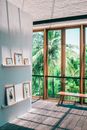 High windows located in spacious interior decorated with pictures on shelves