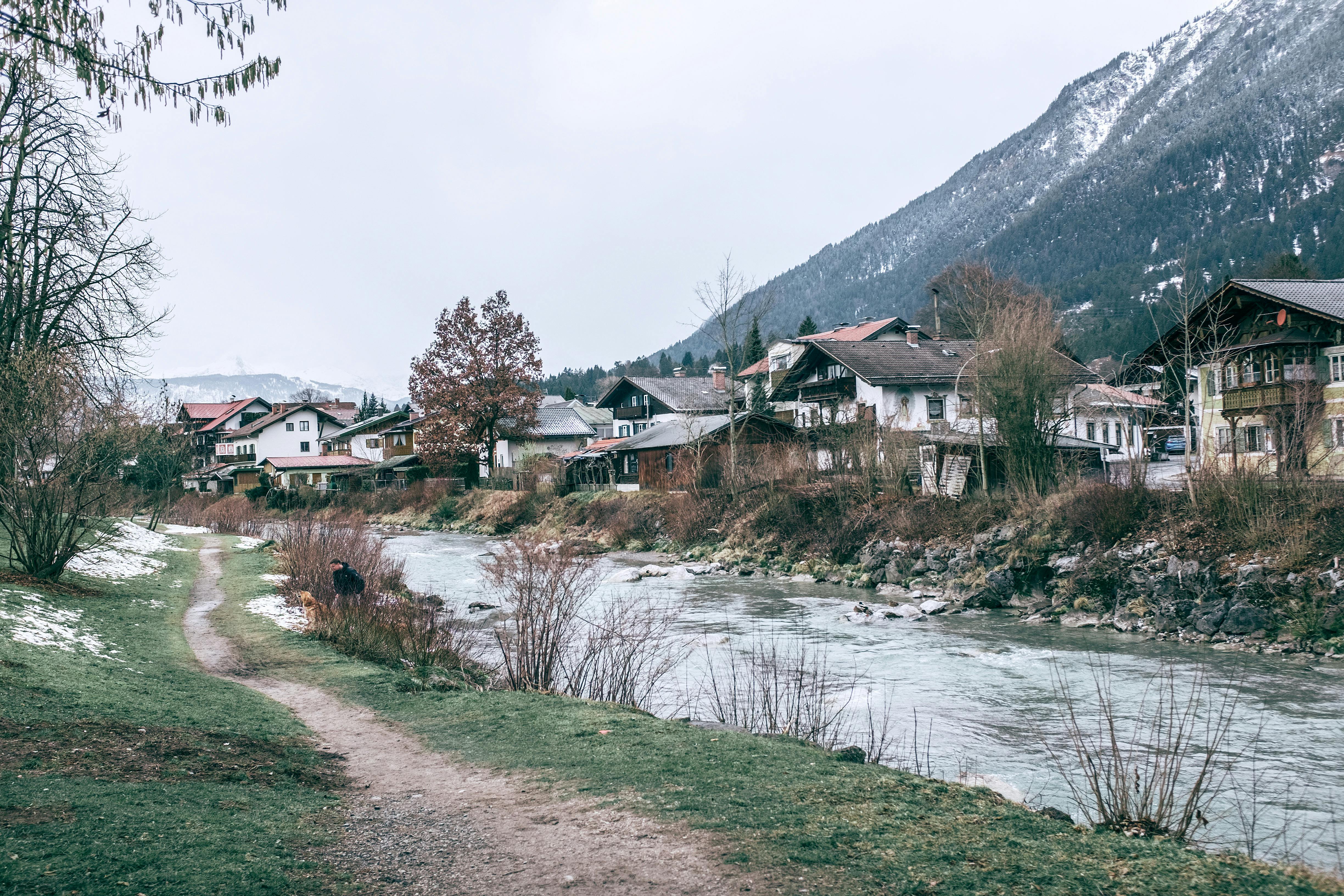 old houses near river and big mountain in winter