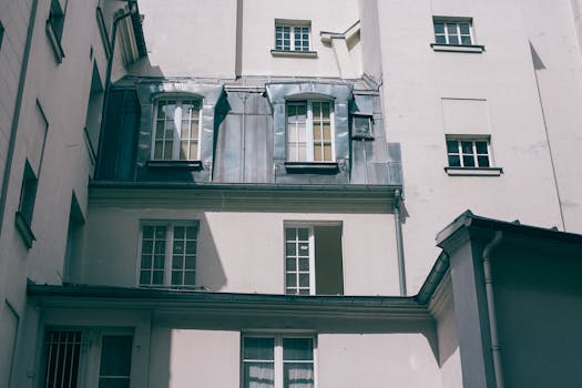 Low angle of old fashioned gray residential house with square windows at daytime