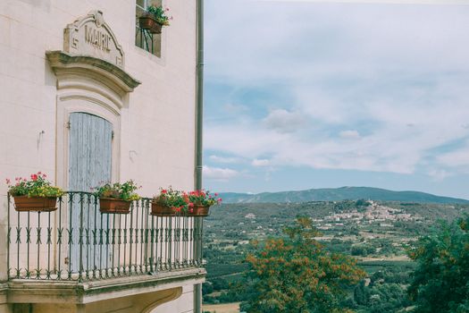 Stone building with balcony and potted plants