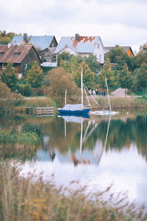 Boat moored on pier of lake in countryside