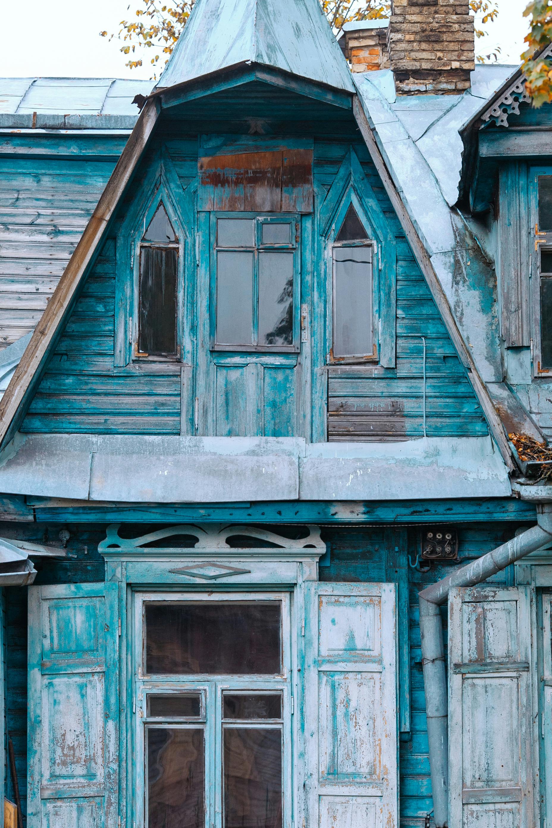 shabby house with shutters in countryside