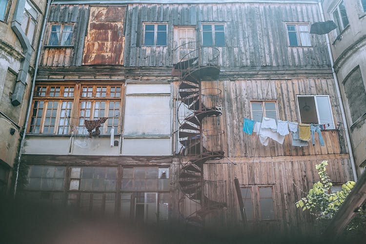 Shabby Poor Condominium With Weathered Spiral Staircase