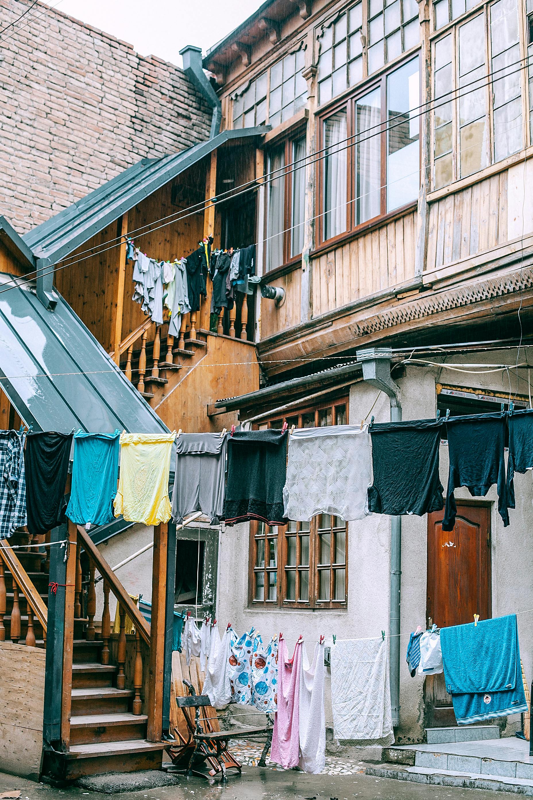 Laundry drying on clothesline outside shabby poor house