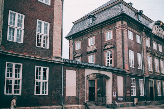 A beautiful vintage brick building with large windows in an urban setting.