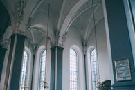 Spacious hall of baroque catholic cathedral with arched windows