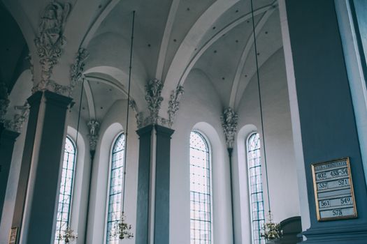 Spacious hall of baroque catholic cathedral with arched windows