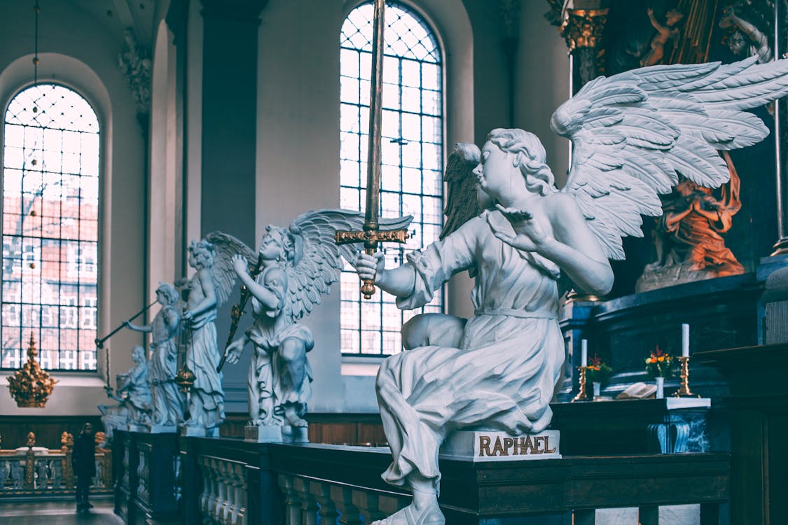 Baroque altarpiece decorated with white angels sculptures on marble railing located in Church of Our Saviour Copenhagen Denmark