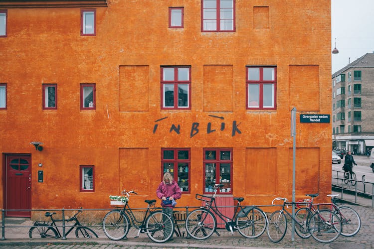 Colorful Building With Shop Downstairs Near Parked Bicycles