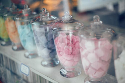 Assortment of various multicolored sweets on counter in store