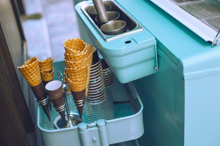 Light Blue Basket With Ice Cream Cones Placed Near Glasses With Scoop