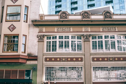 A detailed view of an ornate urban building facade showcasing architectural elements and decorative designs.