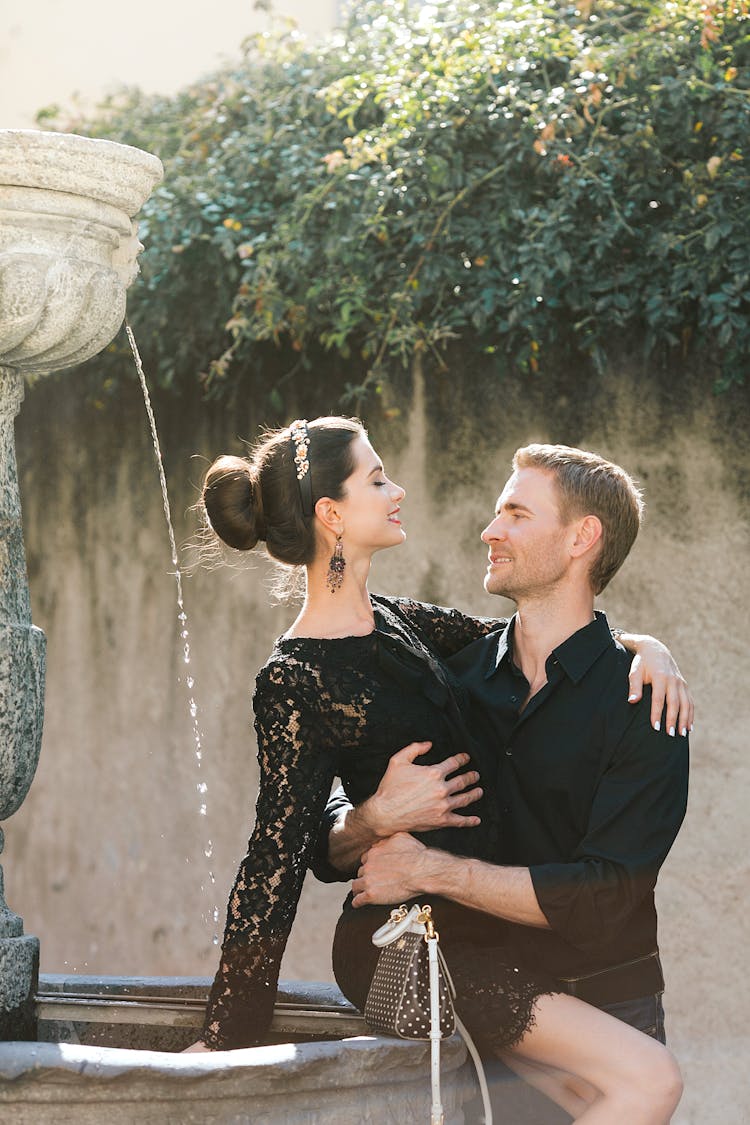 Content Couple Embracing On Fountain In Summer City