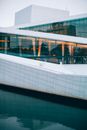 Modern Opera House exterior against river in town