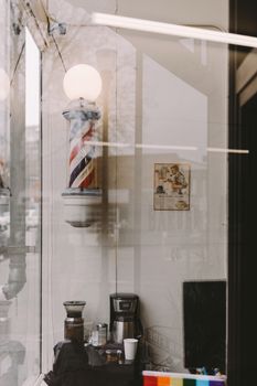 Coffee machine and grinder near glass wall and decoration in form of American and LGBTQ flags in house