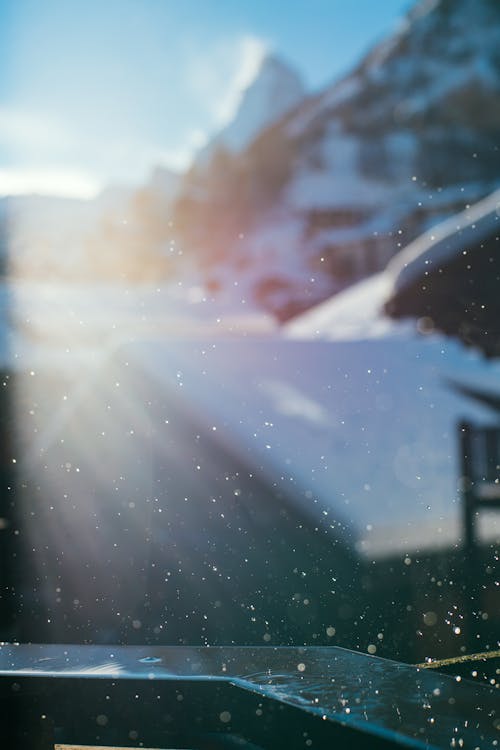 High snowy mountains under blue cloudy sky in sunshine · Free Stock Photo