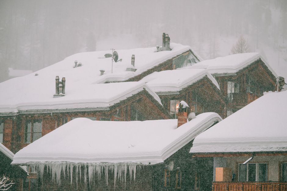 residential roof with heavy snow and thick ice ridges at the eaves - ice dam insurance claim residential roof with heavy snow and thick ice ridges at the eaves - ice dam insurance claim