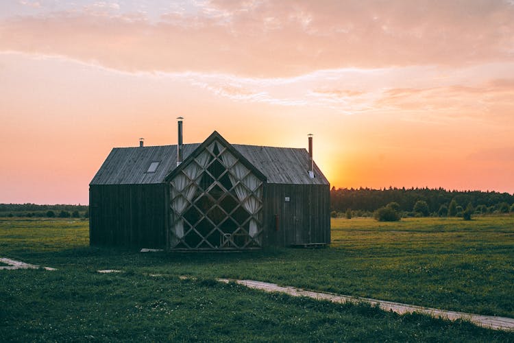 Rural Wooden House In Meadow